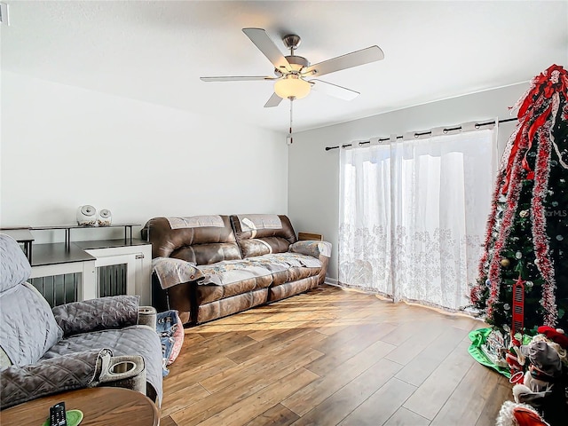 living room featuring light hardwood / wood-style flooring and ceiling fan