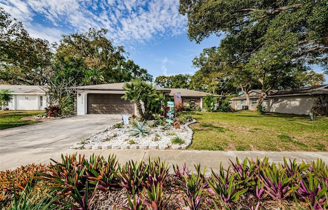 ranch-style home featuring a garage and a front yard