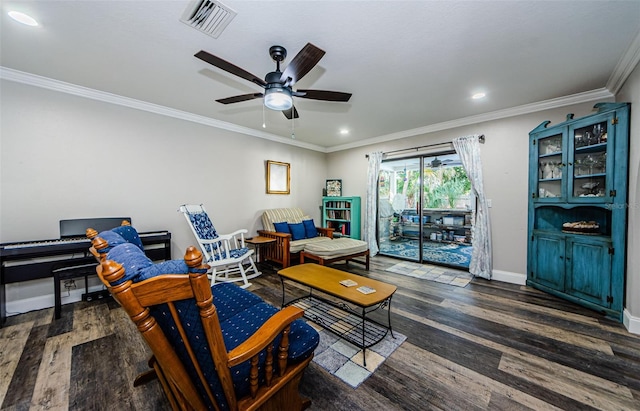 living room with dark hardwood / wood-style flooring, ceiling fan, and crown molding