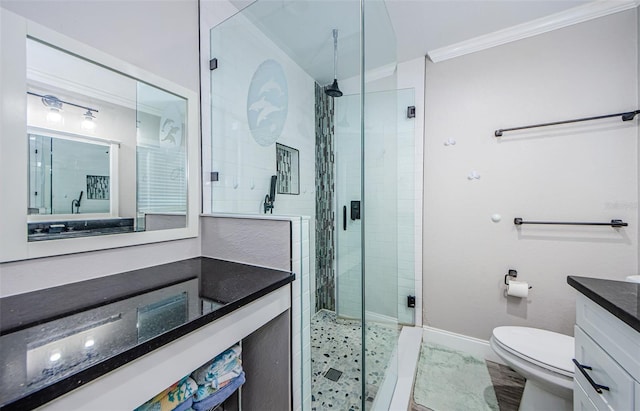 bathroom with vanity, toilet, a shower with door, and ornamental molding