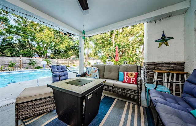 view of patio with ceiling fan, a fenced in pool, and an outdoor hangout area