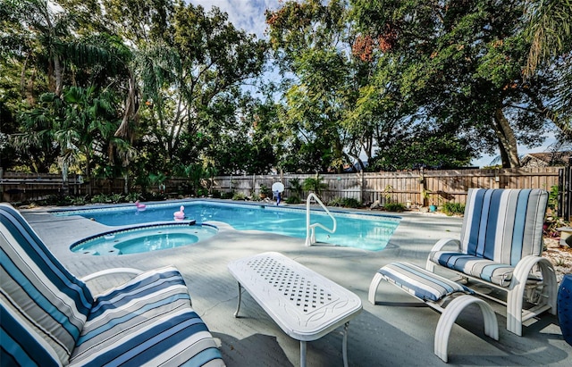 view of pool with an in ground hot tub