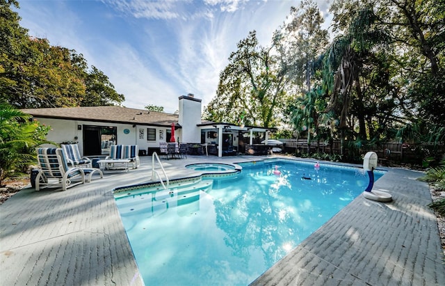 view of pool with an in ground hot tub and a patio