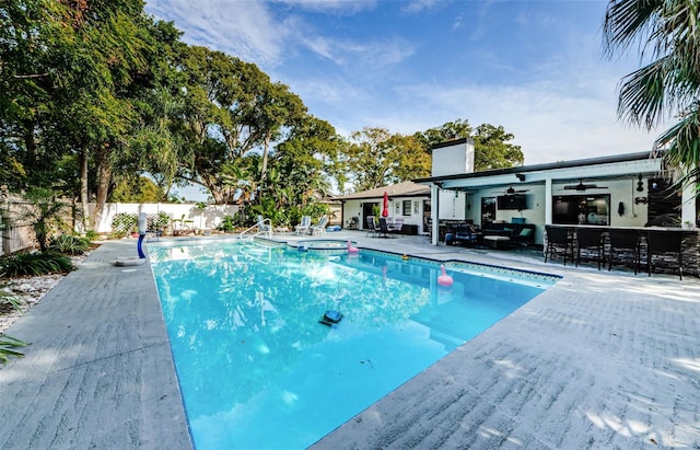 view of swimming pool with ceiling fan, a patio area, an outdoor hangout area, and an in ground hot tub