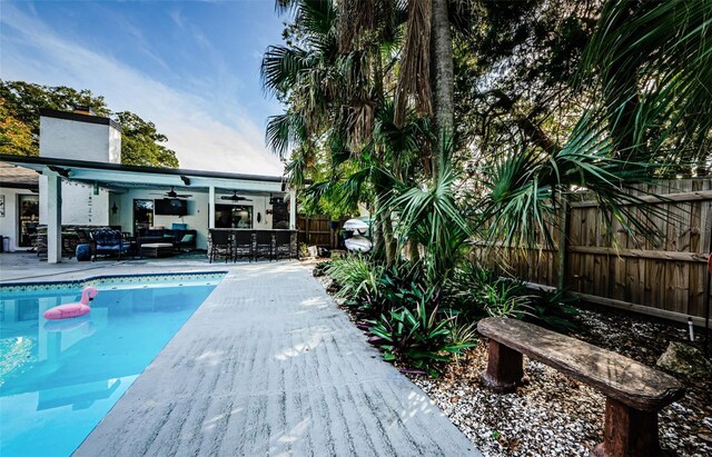 view of pool with ceiling fan and an outdoor living space