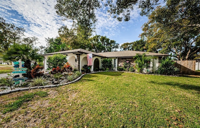 ranch-style house featuring a front lawn