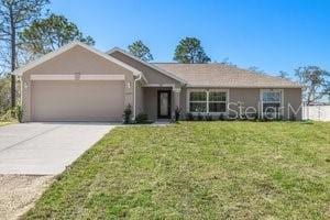 ranch-style home with a garage and a front yard