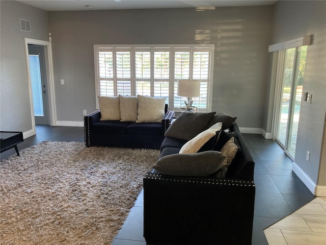 living room with dark tile patterned floors