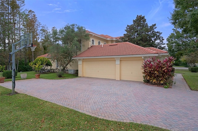 view of property exterior with a garage and a lawn