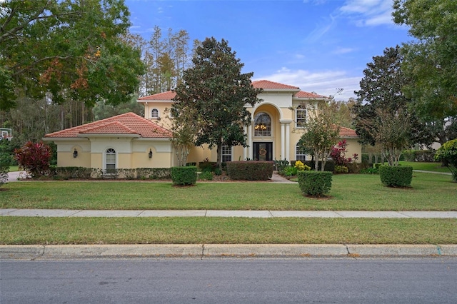 mediterranean / spanish-style house with a front yard