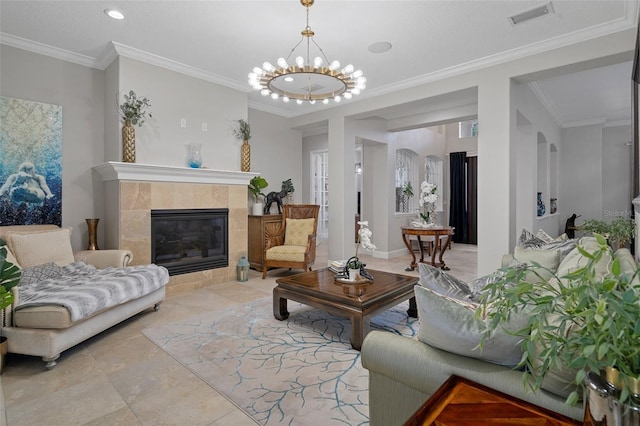 tiled living room featuring crown molding, a fireplace, and a chandelier