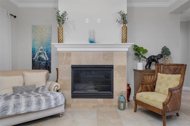 sitting room with ornamental molding and a tile fireplace