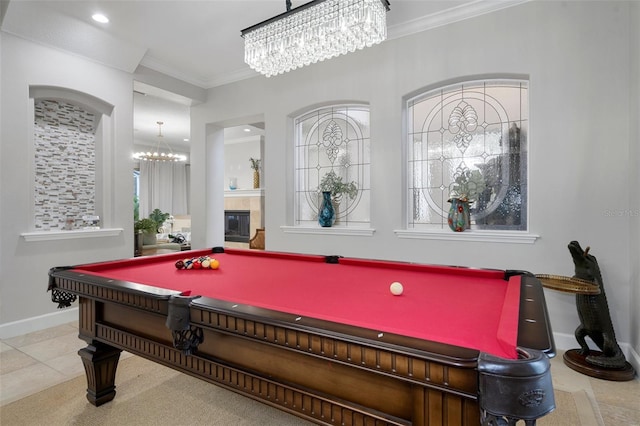 game room featuring light tile patterned floors, crown molding, pool table, and a tiled fireplace