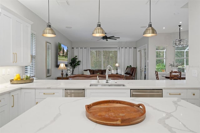 kitchen with sink, stainless steel dishwasher, and decorative light fixtures