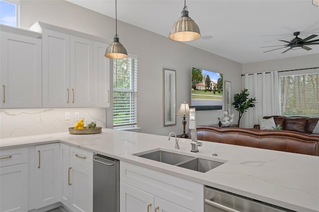 kitchen featuring decorative backsplash, white cabinets, sink, decorative light fixtures, and dishwasher