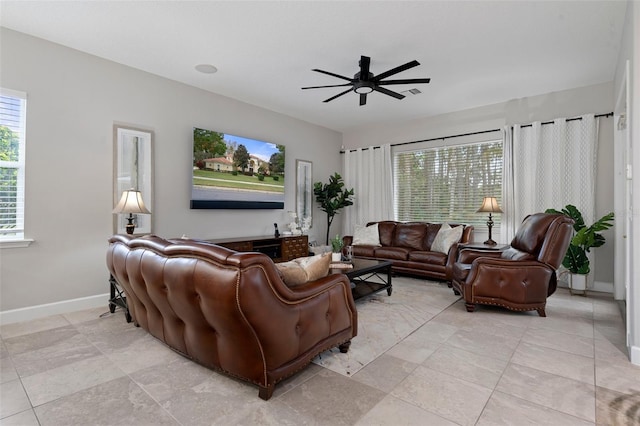 living room featuring ceiling fan and light tile patterned flooring