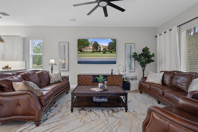 living room with a wealth of natural light and ceiling fan