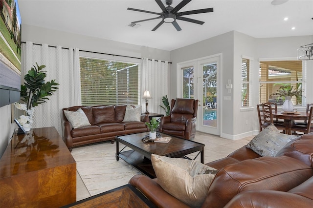 tiled living room featuring plenty of natural light and ceiling fan