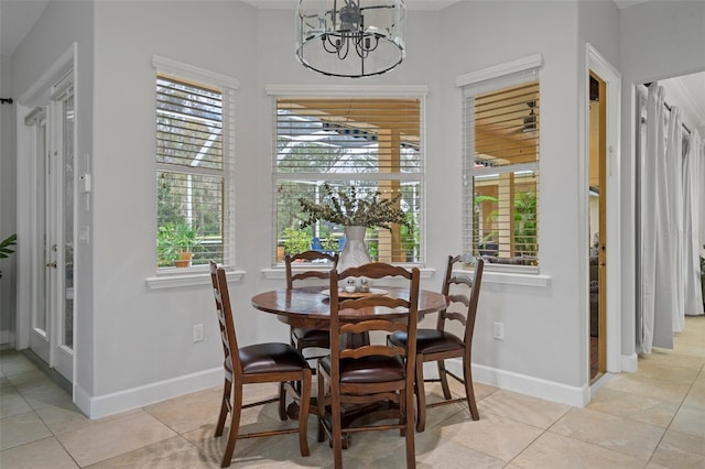 tiled dining area with a chandelier