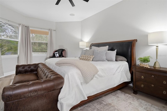 bedroom with ceiling fan and light hardwood / wood-style flooring