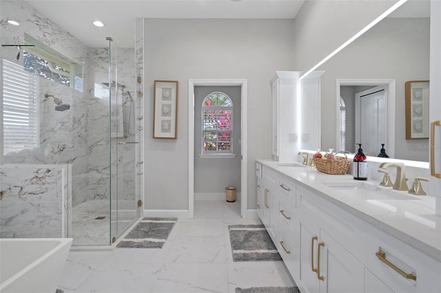 bathroom with plus walk in shower, vanity, and a healthy amount of sunlight