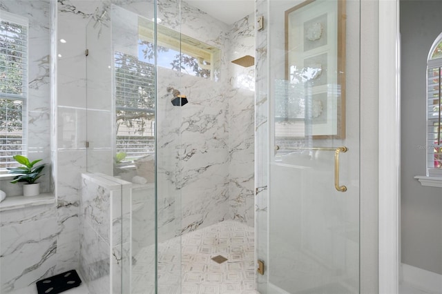 bathroom featuring a shower with shower door