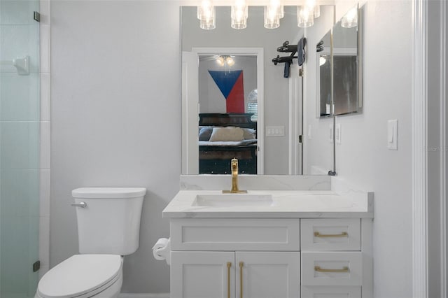 bathroom featuring vanity, toilet, and a shower with shower door