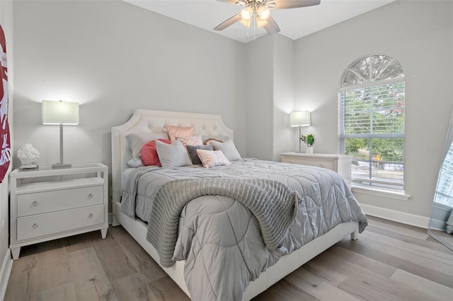 bedroom featuring multiple windows, ceiling fan, and light hardwood / wood-style floors