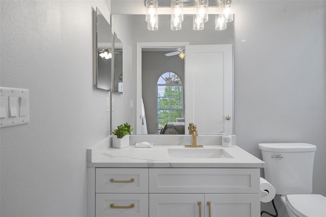 bathroom with ceiling fan, vanity, and toilet