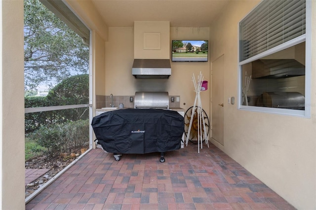 view of patio / terrace featuring a grill and sink