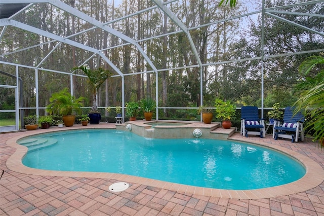 view of swimming pool featuring an in ground hot tub, a patio, and glass enclosure