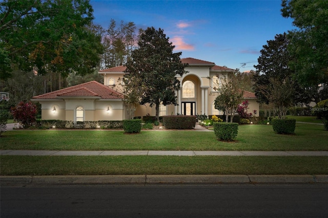 mediterranean / spanish house with a lawn