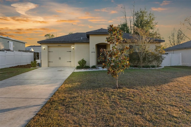 view of front of home featuring a yard and a garage