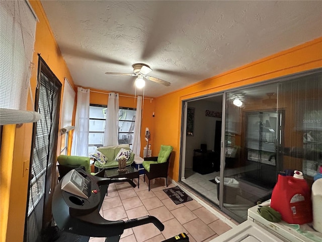 sunroom featuring ceiling fan