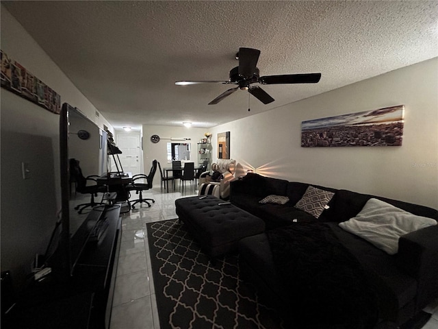 tiled living room featuring ceiling fan and a textured ceiling