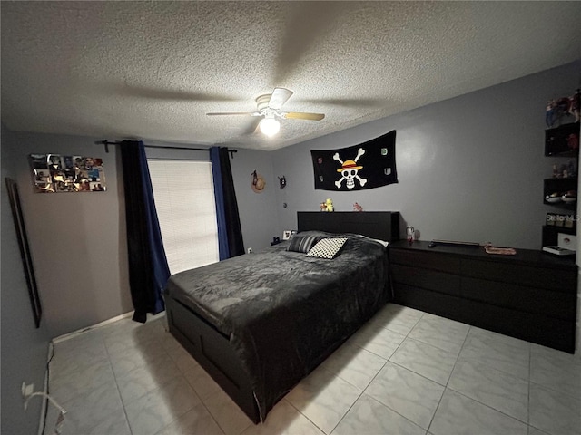 bedroom with ceiling fan and a textured ceiling