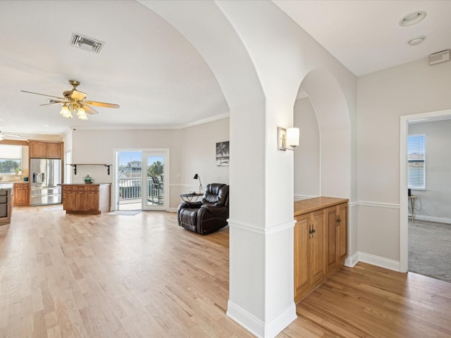 hall featuring crown molding and light hardwood / wood-style flooring