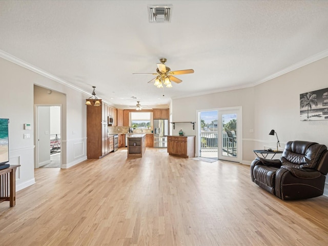 living room featuring ceiling fan, light hardwood / wood-style flooring, and ornamental molding