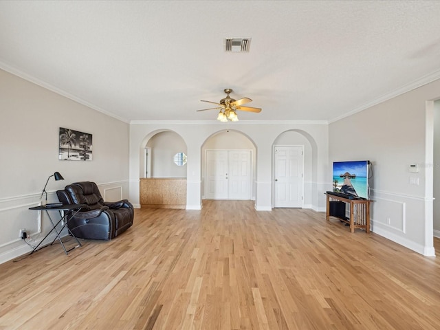 sitting room with ceiling fan, light hardwood / wood-style floors, and ornamental molding