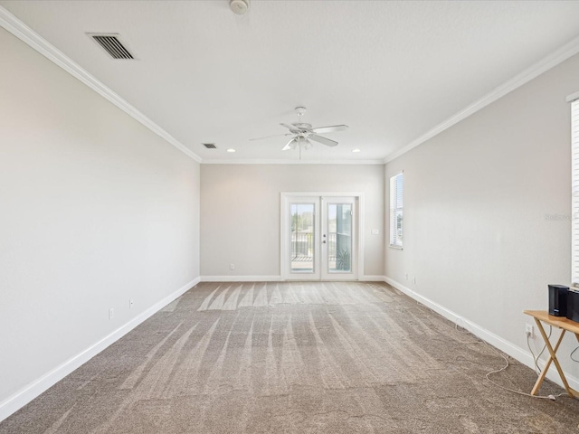 empty room featuring carpet, ceiling fan, ornamental molding, and french doors