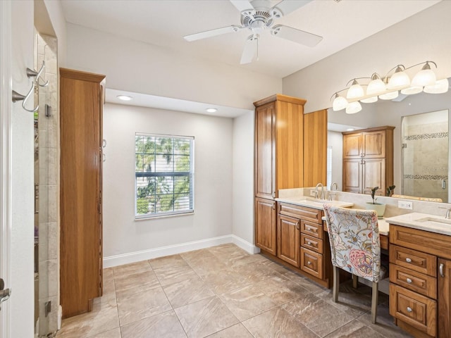 bathroom with a tile shower, ceiling fan, and vanity