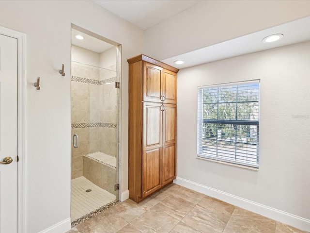 bathroom featuring a shower with shower door