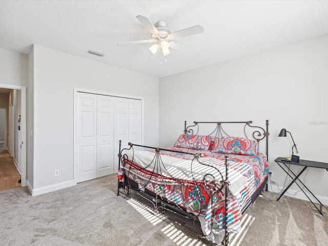 bedroom featuring ceiling fan, a closet, and carpet floors