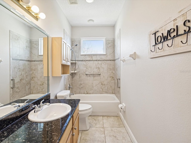 full bathroom with vanity, tile patterned floors, tiled shower / bath, toilet, and a textured ceiling