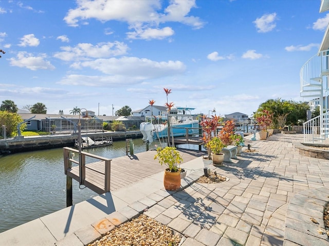 view of patio / terrace featuring a boat dock and a water view