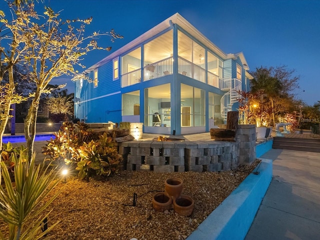 back house at night with a balcony