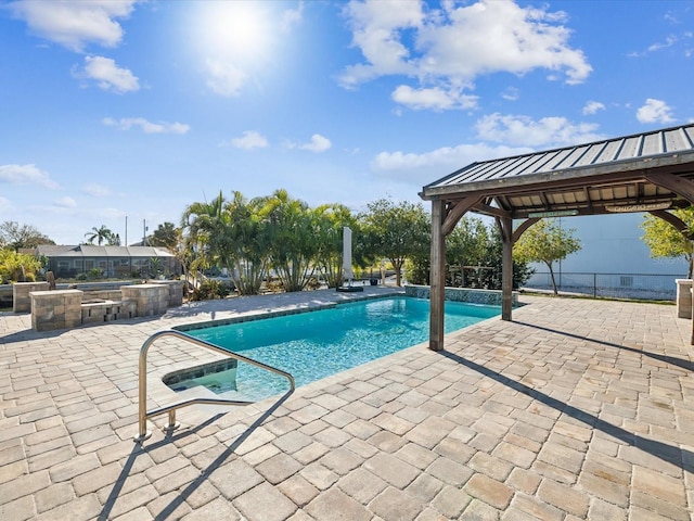 view of pool featuring a gazebo, a patio, and a hot tub