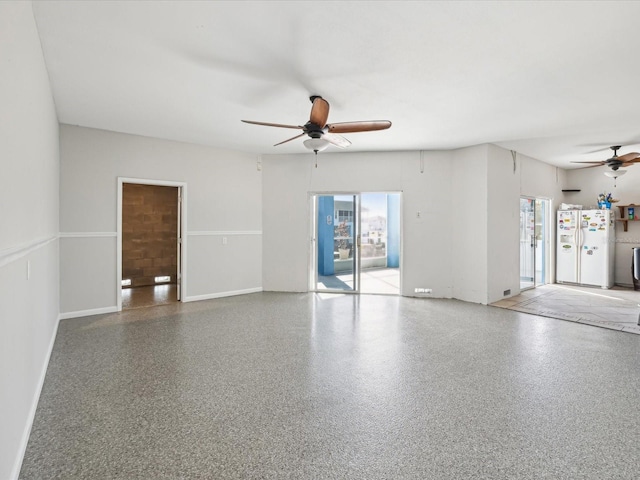 empty room with ceiling fan and plenty of natural light