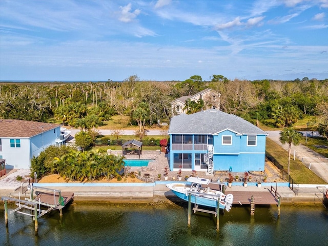 rear view of house with a balcony and a water view