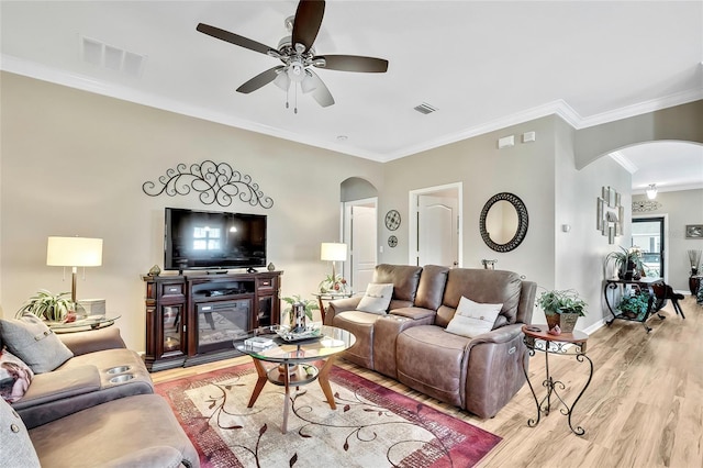 living room with ceiling fan, light hardwood / wood-style floors, and crown molding